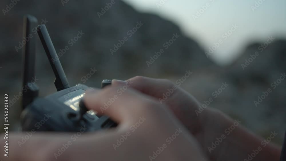 Aircraft Pilot operating Joystick Of Controller to take some videos in Mallorca, Spain Islands.