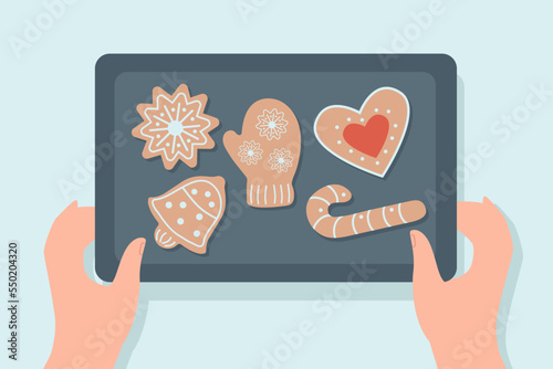 Hands of person holding tray with homemade gingerbread cookies. Cartoon character making pastry in shape of Christmas symbols flat vector illustration. Desserts, holidays, bakery concept for banner