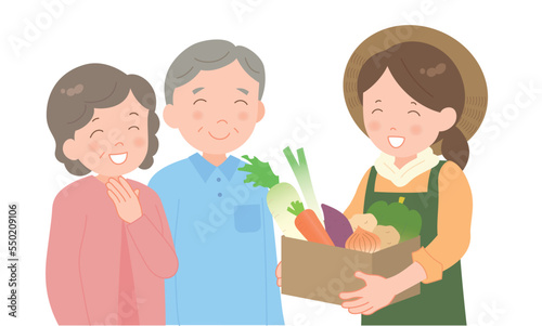 冬野菜の段ボールを持つ女性とシニア夫婦 