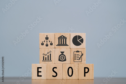 word ESOP with wood building blocks, light gray background. document with numbers on background, business concept. space for text in right. front view. esop - EMPLOYEE STOCK OWNERSHIP PLAN. photo