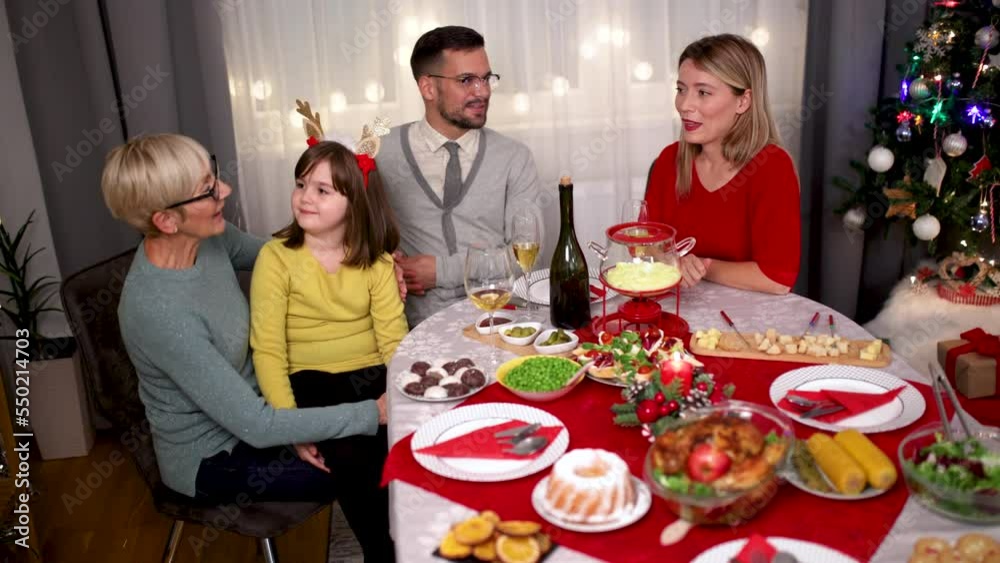Happy multi-generation family enjoying in a lunch together at home. Family on Christmas dinner at home Happy multi-generation family enjoying in a lunch together at home. Family on Christmas dinner at home