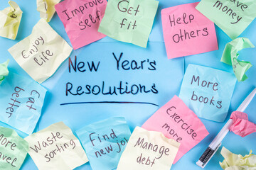 New year goals or resolutions on bright colorful paper stickers. New Year goals List 2023, plan listing of new year beginnings goals and resolutions setting. Flat lay copy space on blue background