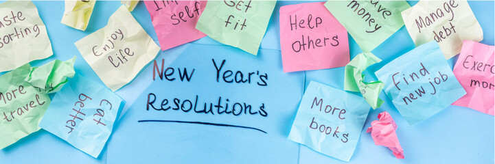 New year goals or resolutions on bright colorful paper stickers. New Year goals List 2023, plan listing of new year beginnings goals and resolutions setting. Flat lay copy space on blue background