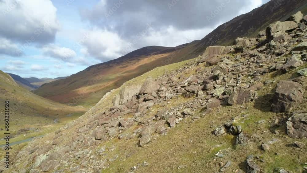 Low and Close Aerial Drone Shot Flying over Big Rocks and Boulders down Honister Pass Mountain Pass on Sunny and Cloudy Day Lake District Cumbria United Kingdom Low and Close Aerial Drone Shot Flying over Big Rocks and Boulders down Honister Pass Mountain Pass on Sunny and Cloudy Day Lake District Cumbria United Kingdom