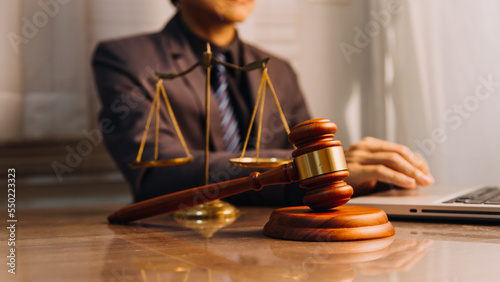 Wallpaper Mural Justice and law concept.Male judge in a courtroom with the gavel, working with, computer and docking keyboard, eyeglasses, on table in morning light Torontodigital.ca