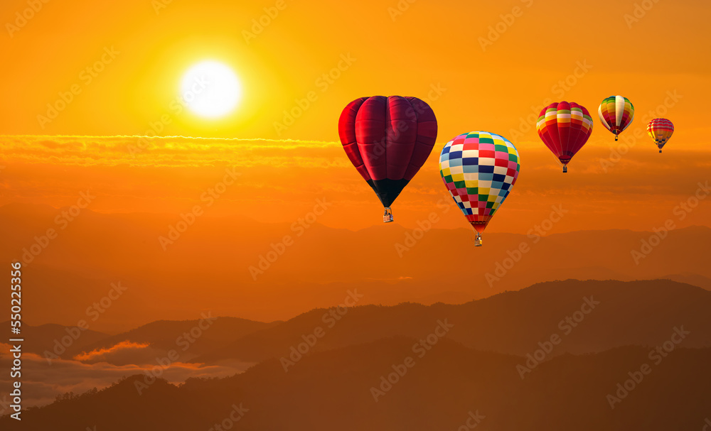 Fototapeta premium color hot air balloon in sky at sunrise time, Colorful hot-air balloons flying in orange sky and sunset. Sport, adventure, transportation,Travel.