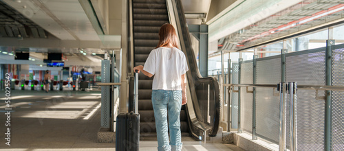 woman traveler walking in International Airport or Subway platform. Tourist with luggage for Time to Travel, vacation and trip concepts
