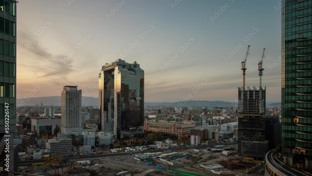 Time Lapse: Sunset over buildings near Osaka Station in Umeda district