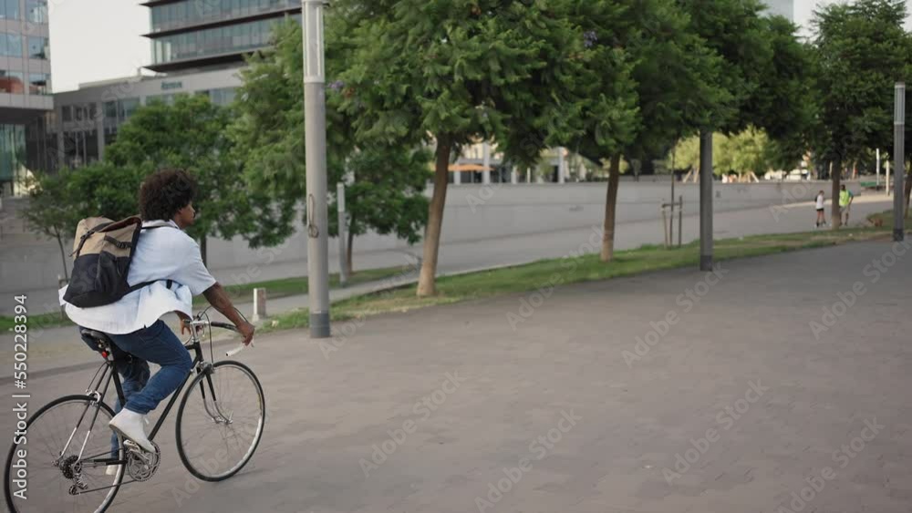 Modern professional man going to work by bicycle - Sustainable transport inn the city Modern professional man going to work by bicycle - Sustainable transport inn the city