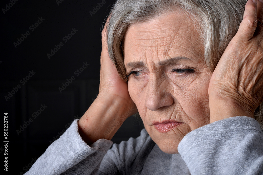 Elderly woman holding her hand to her throat. Disease Elderly woman holding her hand to her throat. Disease