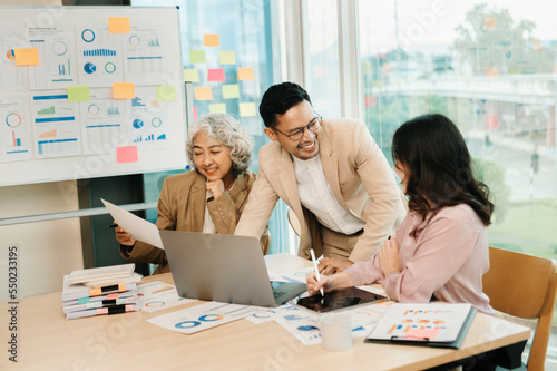 Office colleagues have a casual discussion. During a meeting in a conference room, a group of business teem sit in the conference room new startup project