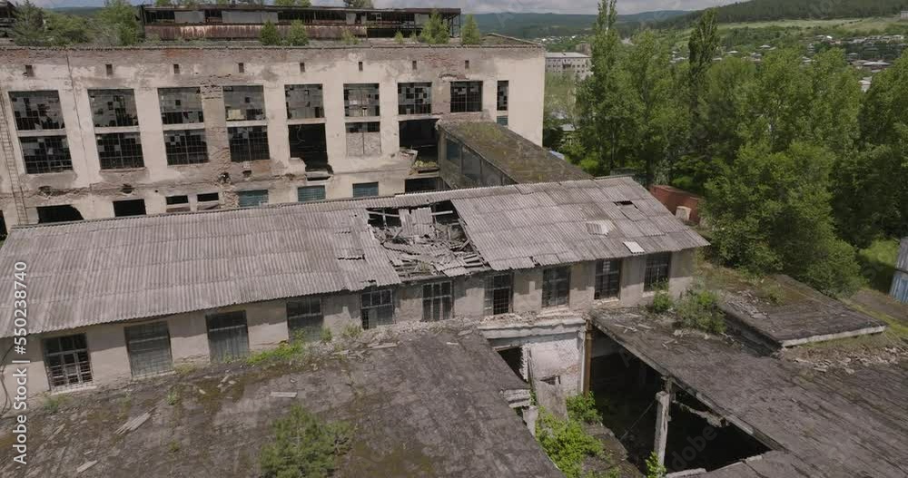 Damaged Roof And Exterior Wall Of A Deserted Industrial Factory In Khashuri, Georgia. aerial Damaged Roof And Exterior Wall Of A Deserted Industrial Factory In Khashuri, Georgia. aerial