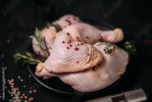 raw chicken legs on a dark background 