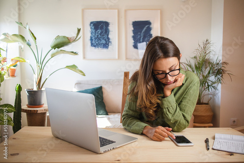 Woman bored and procrastinating working from home