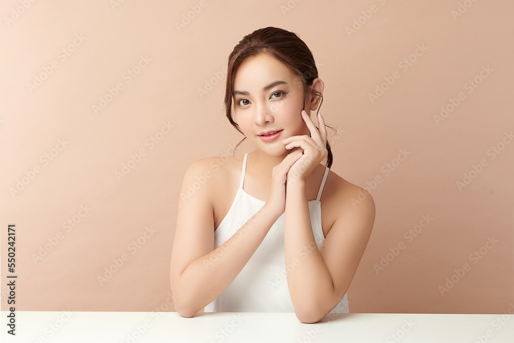 Beautiful young asian woman with clean fresh skin on beige background, Face care, Facial treatment, Cosmetology, beauty and spa, Asian women portrait. Beautiful young asian woman with clean fresh skin on beige background, Face care, Facial treatment, Cosmetology, beauty and spa, Asian women portrait.