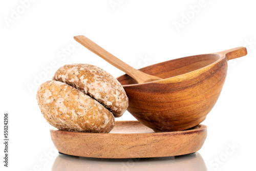 Two sweet delicious gingerbread cookies with a wooden cup on a wooden plate, macro, isolated on white background.