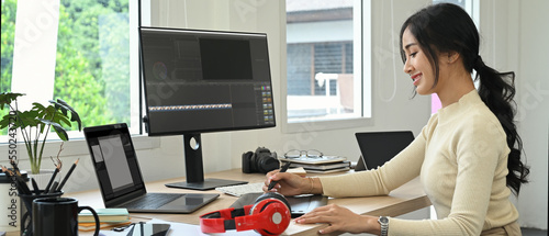 Image of female video editor working with footage and post production montage in creative office studio