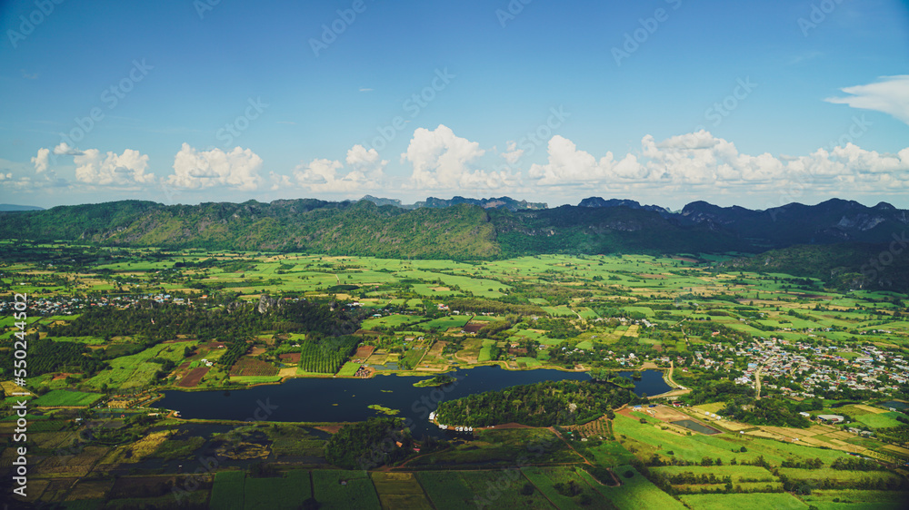 Obraz premium Picture from the highest point of Wat Khao Sam Yot. Phu Pha Man District Khon Kaen province with the sky, rice fields, mountains surrounding the countryside in Thailand.