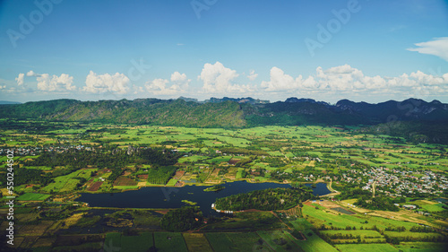 Picture from the highest point of Wat Khao Sam Yot.  Phu Pha Man District  Khon Kaen province with the sky, rice fields, mountains surrounding the countryside in Thailand.
