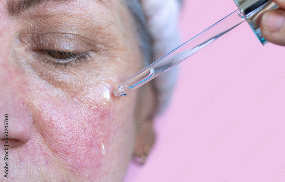 elder senior lady after 50 years old woman doing facial massage gua sha