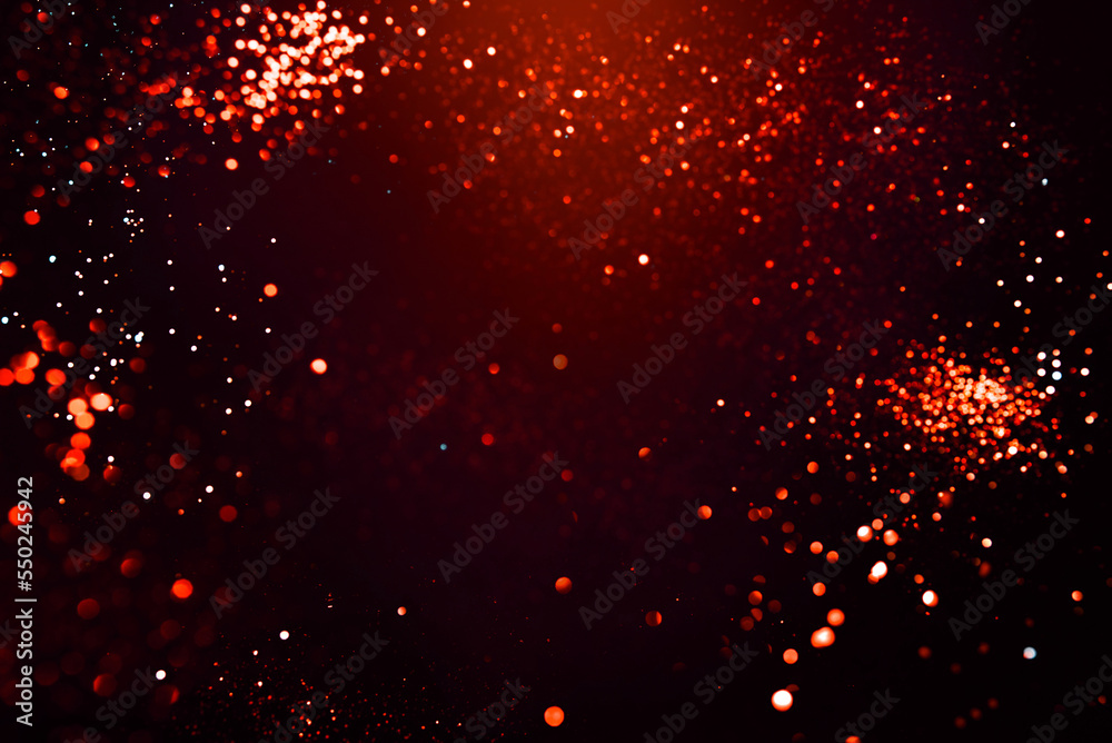 Red abstract bokeh on black background. Holiday concept