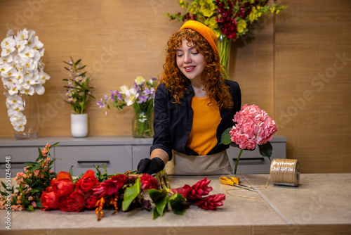 Florist working with the flowers in a flower shop photo