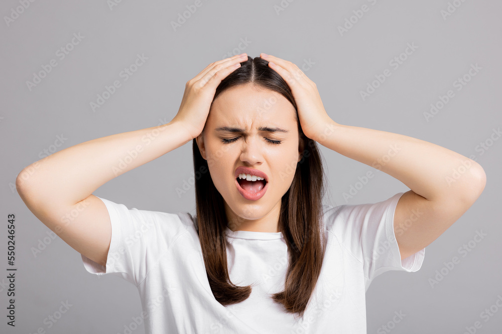 Close up shot portrait of screaming crying emotional angry woman lady standing in grey studio background isolated. Emotional, young face. Female half-length portrait. Emotions, expression concept. Close up shot portrait of screaming crying emotional angry woman lady standing in grey studio background isolated. Emotional, young face. Female half-length portrait. Emotions, expression concept.