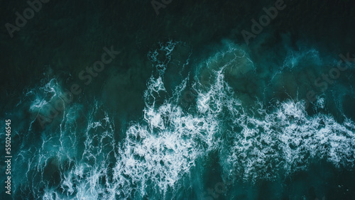 Colorful beach and sea in summer colours. Coast from aerial view. Exclusive landscape scene from nature. Waves, blue water, gold sand, turquoise shore, rocks, stones, premium exotic background