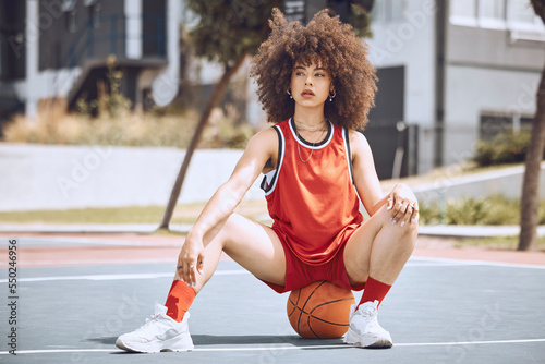 Basketball player with funky, confident and cool attitude ready for competition, game or fit training match on a sports court. Beautiful black woman, healthy athlete and motivation female with afro photo
