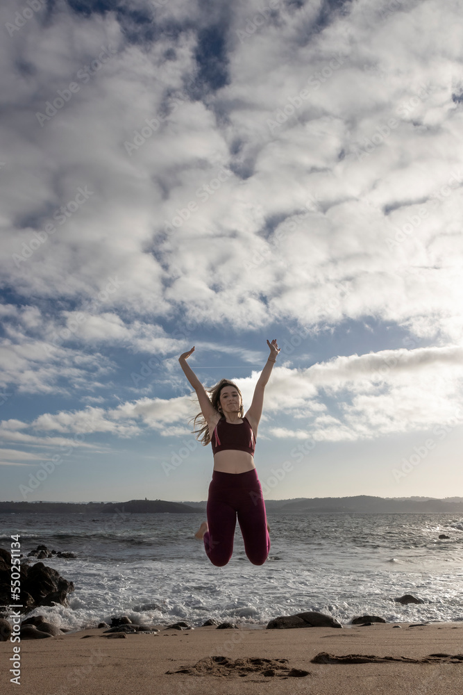 Woman Jumping In The Air On Beach Woman Jumping In The Air On Beach