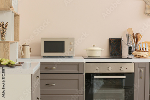 Interior of modern light kitchen with microwave oven