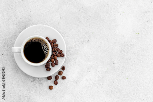 Black coffee - espresso - in white cup with coffee beans