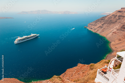 Santorini island, Greece. Big cruise ship near the coast.