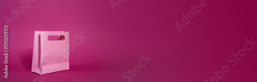 sale concept. Shopping bag isolated on pink plain neutral background, christmas gift valentines day birthday girl presents, black friday, cyber monday. Extra wide banner , copy space, shop, center,buy