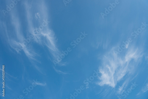 Whispy white clouds against blue sky in daylight