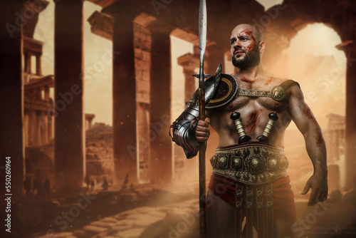 Shot of serious roman gladiator with naked torso and long spear isolated on grey background.
