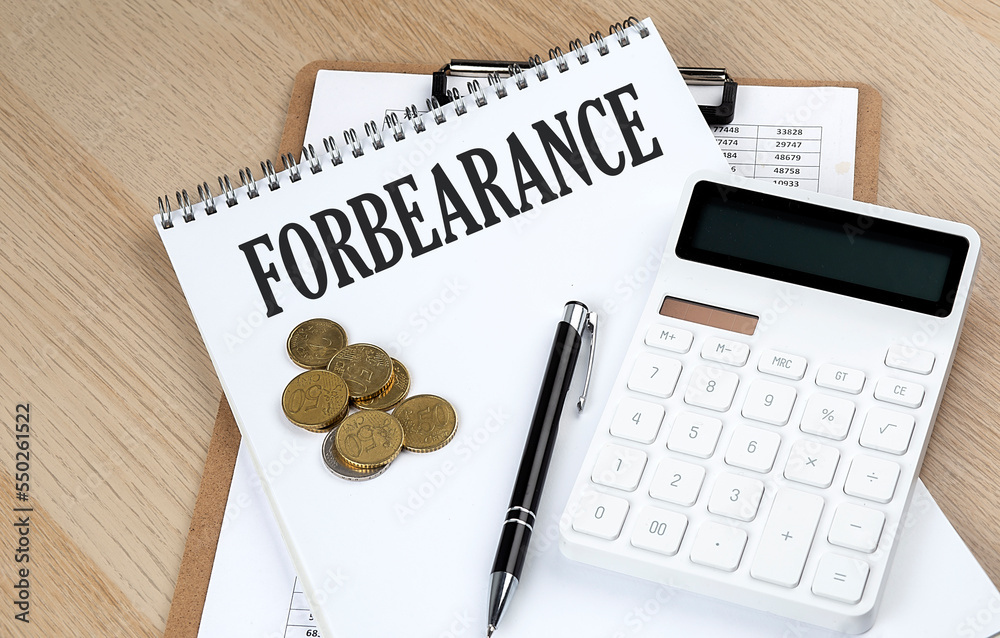 FORBEARANCE text on a notebook with chart and calculator and coins, business concept FORBEARANCE text on a notebook with chart and calculator and coins, business concept