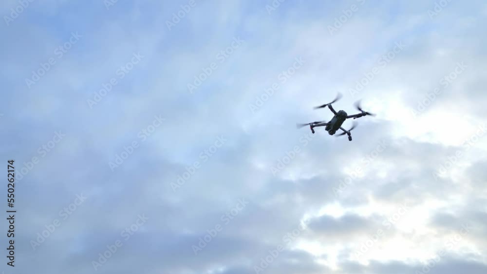 Drone In Flight Against Cloudy Sky At Sunset. low angle, drone shot Drone In Flight Against Cloudy Sky At Sunset. low angle, drone shot