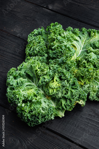 Kale salad leaves product of autumn, on black wooden table background