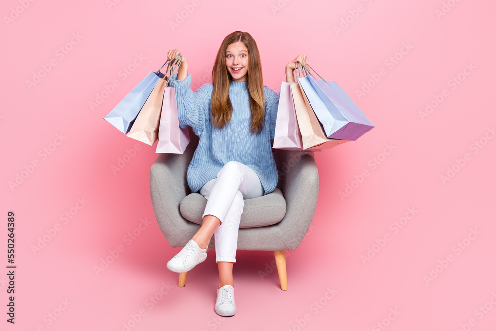 Full body size photo of teenager wear blue knitwear jumper hold stack bargains celebrate black friday big sale isolated on pink color background Full body size photo of teenager wear blue knitwear jumper hold stack bargains celebrate black friday big sale isolated on pink color background