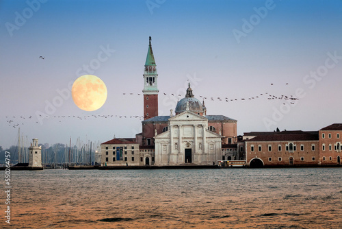 Venezia. Isola di San Giorgio Maggiore con luna e scia di gabbiani in emigrazione photo