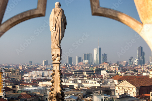 Milano. Veduta con statua sul pinnacolo dalla terrazza del Duomo verso i grattacieli di City Life photo