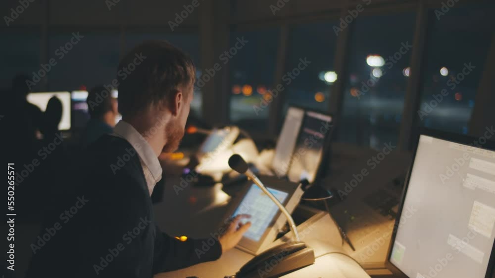Close up of traffic control center operator working in airoport tower at night