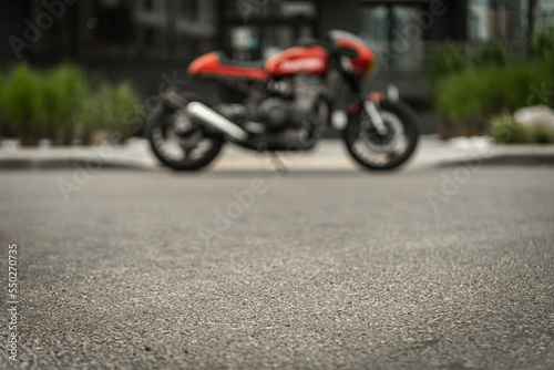 Photo of asphalt in front of a parked motorcycle © uladzislaulineu