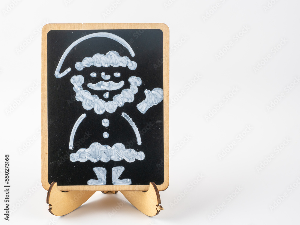 Father Christmas drawn on a black chalkboard for advertising on a white background Father Christmas drawn on a black chalkboard for advertising on a white background