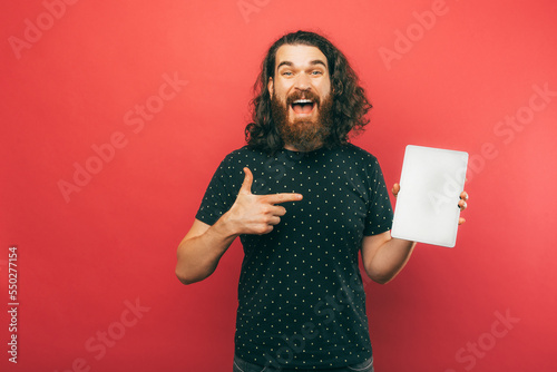 Canvas Print Oh look at this offer I am pointing at on this tablet screen says a bearded man