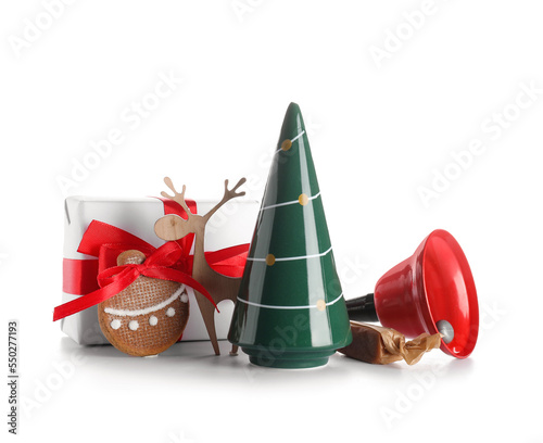 Ceramic Christmas tree, gift box, decorations and sweets on white background