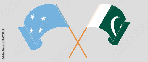 Crossed and waving flags of Micronesia and Pakistan
