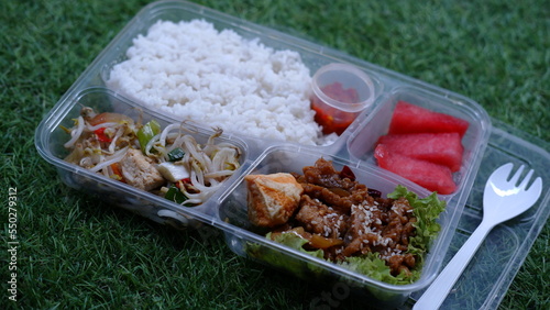 Catering food with healthy balanced diet delicious lunch box boxed take away deliver packed ready meal in black container dinner, meal, brakfast. Japanese bento, ready to eat.