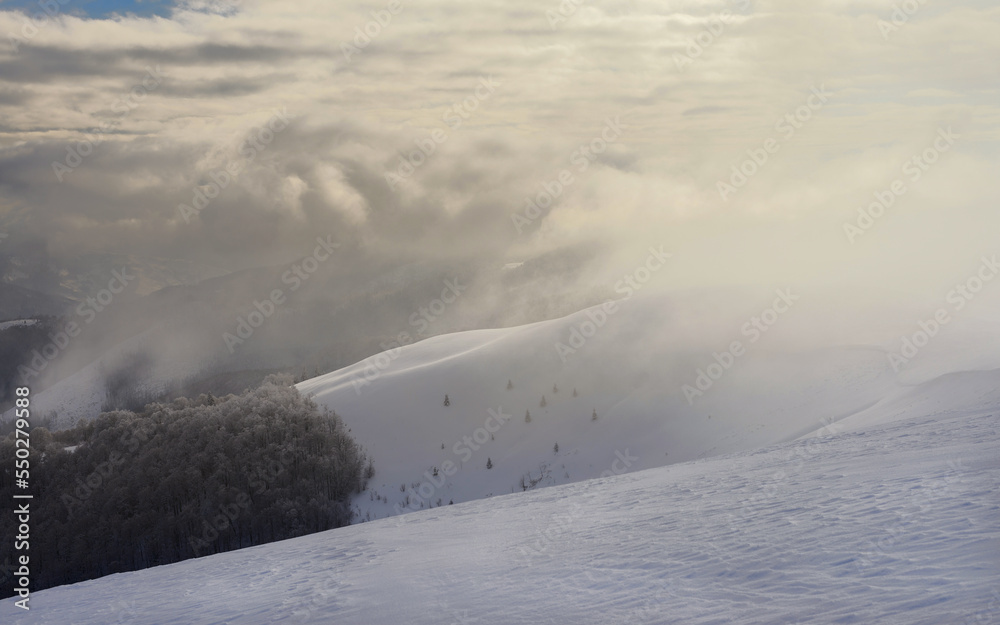 Mountain range covered with clouds. Winter mountain landscape. Mountain range covered with clouds. Winter mountain landscape.